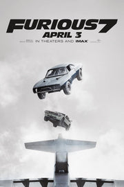 Furious 7 poster features two cars falling above an airplane tail through a pale gray cloudy sky, with April 3 text.