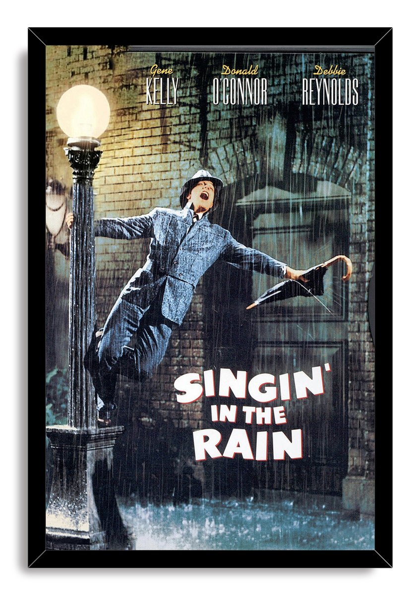 Singin' in the Rain framed wall art print of Gene Kelly dancing in rainfall beside a streetlamp, bordered by a black frame.