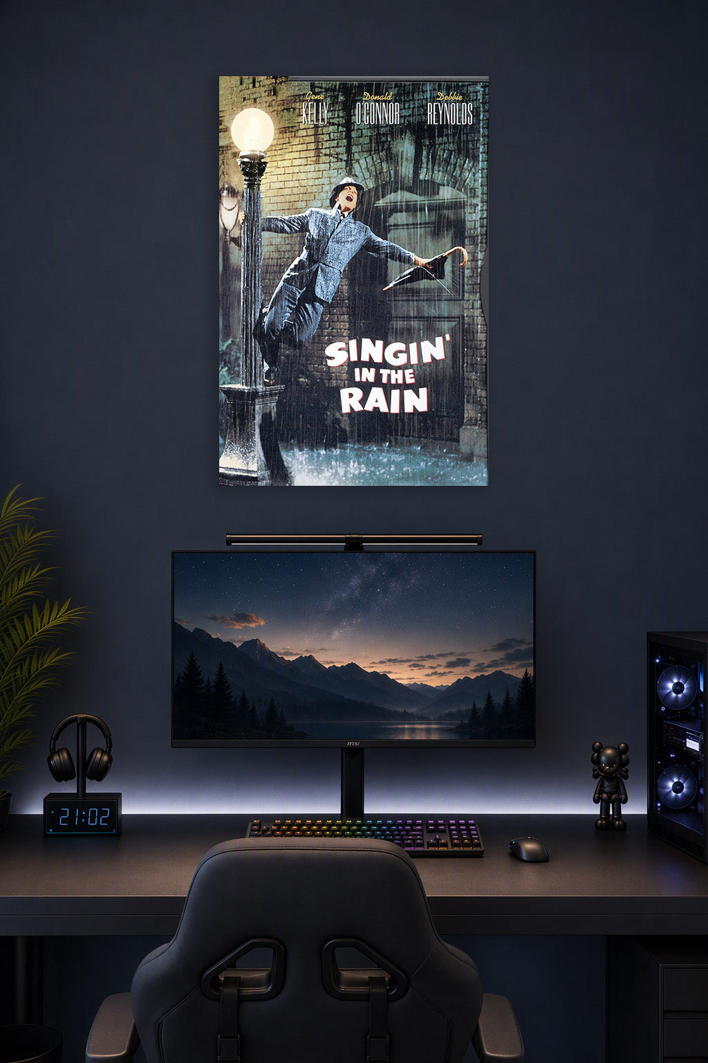 Gene Kelly Singin' in the Rain in a gaming desk setup above a monitor.