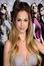 Genesis Rodriguez poster portrait in a strapless silver dress, posed before three stylish women in sunglasses.