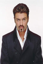 George Michael poster features a front-facing portrait in a dark double-breasted coat and open white shirt on white.