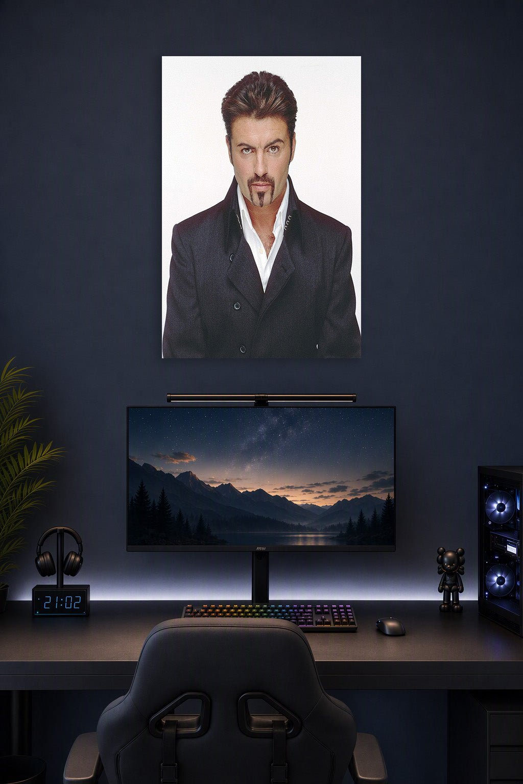 George Michael in a gaming desk setup above a monitor.