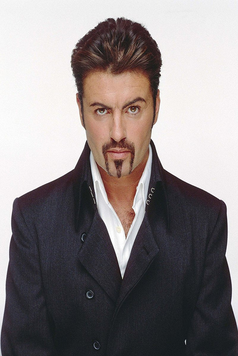 George Michael poster features a direct portrait in a dark double-breasted coat and open white shirt against white.