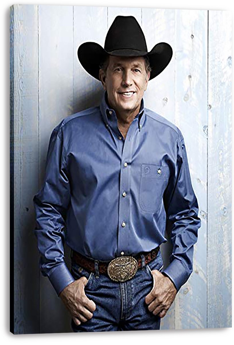 George Strait canvas wall art print with wrapped edges, portraying him smiling in a cowboy hat, blue shirt, jeans, and belt buckle.