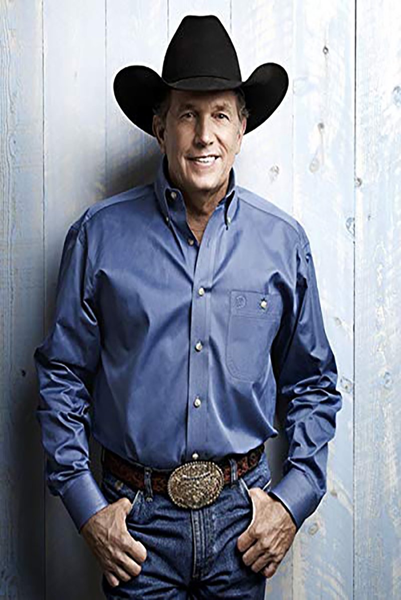 George Strait wall art print featuring the country singer in a black cowboy hat and blue shirt against pale wood panels.