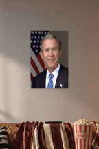 George W. Bush in a cozy movie room above a brown sofa with popcorn.