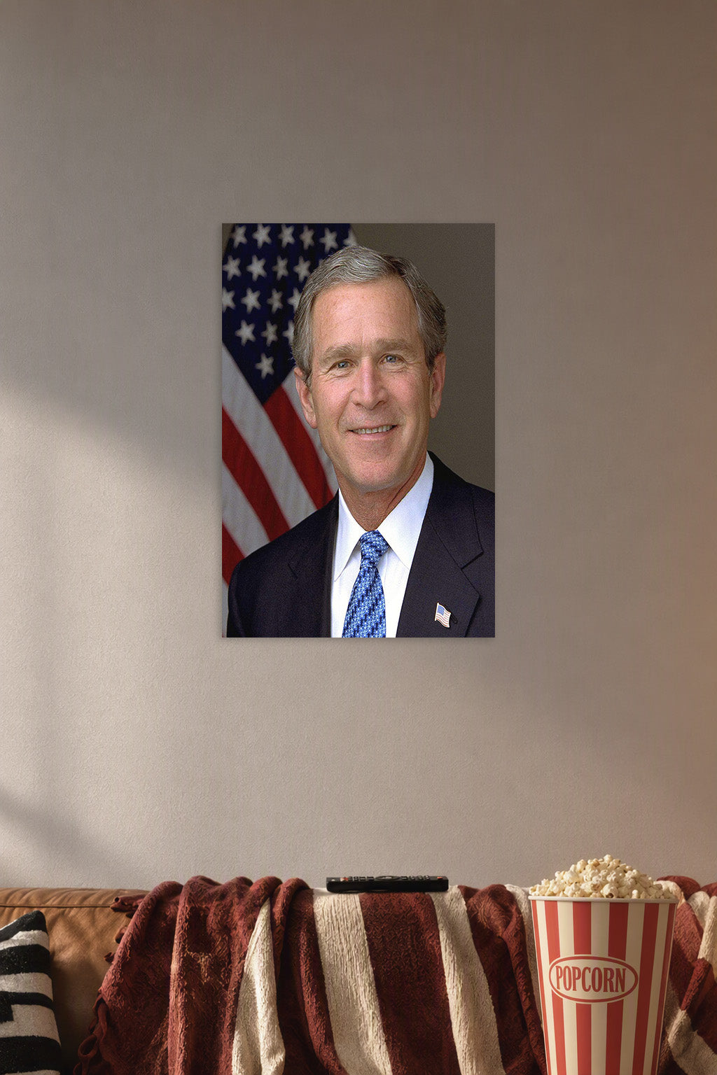 George W. Bush in a cozy movie room above a brown sofa with popcorn.