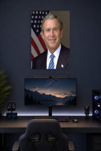 George W. Bush in a gaming desk setup above a monitor.
