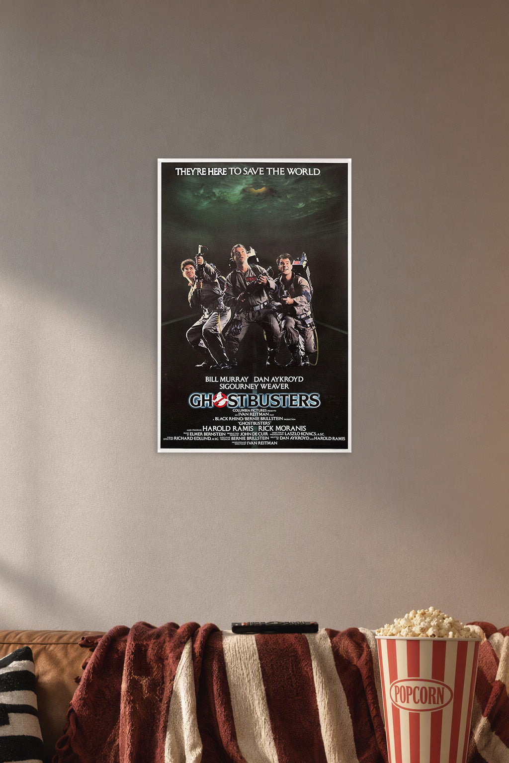 Ghostbusters in a cozy movie room above a brown sofa with popcorn.