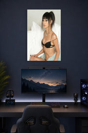 Glamorous Asian Woman in a gaming desk setup above a monitor.