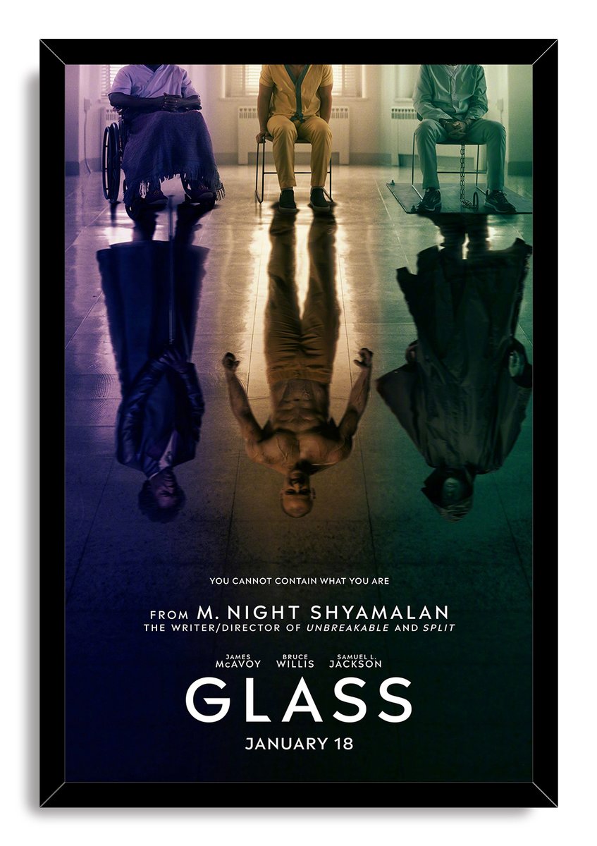 Glass movie poster wall art print in a black frame, with three seated figures and dark mirrored alter-ego reflections.
