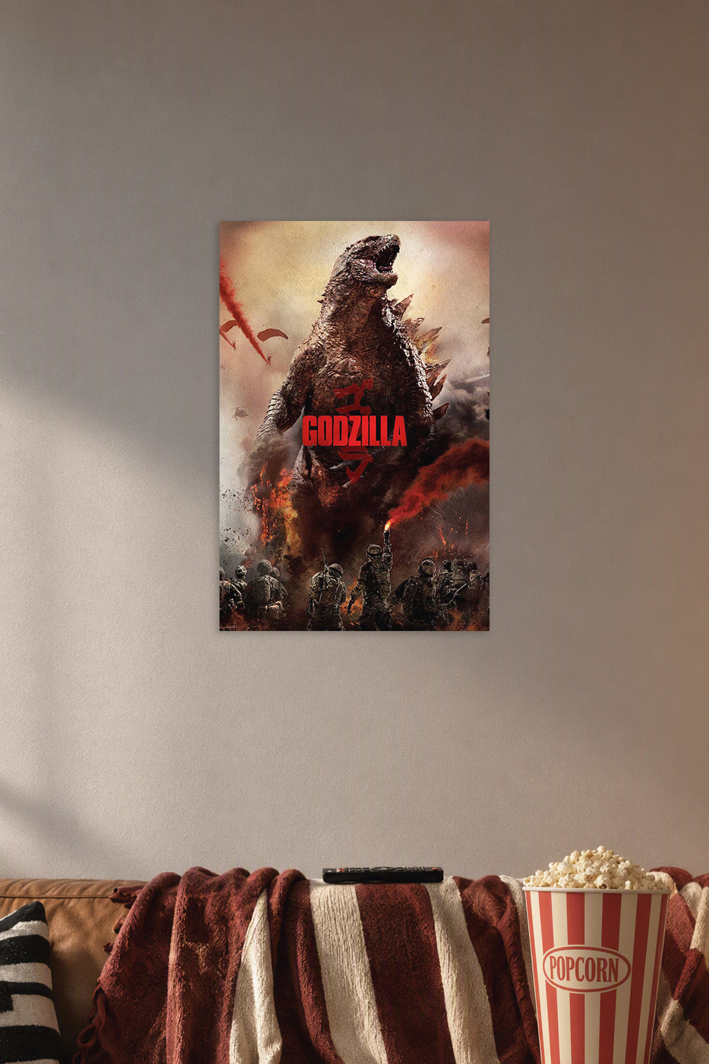Godzilla in a cozy movie room above a brown sofa with popcorn.