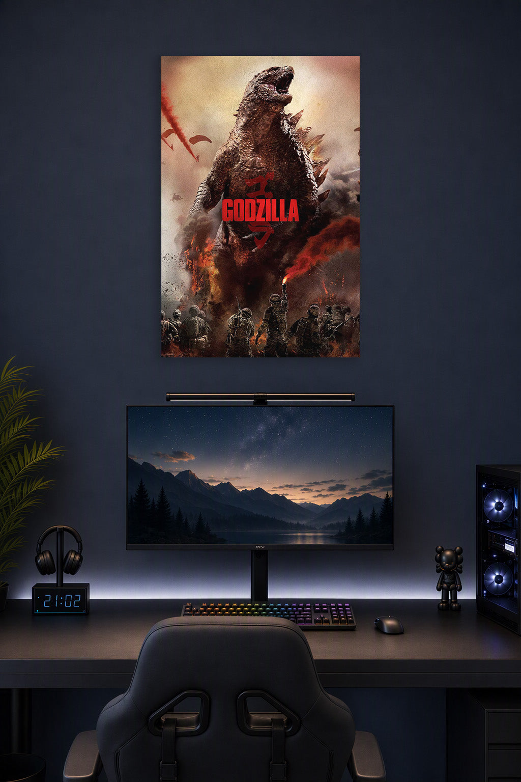 Godzilla in a gaming desk setup above a monitor.