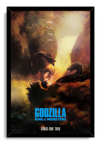 Godzilla framed wall art print features Godzilla battling three-headed King Ghidorah in a fiery cloudscape within a black frame.