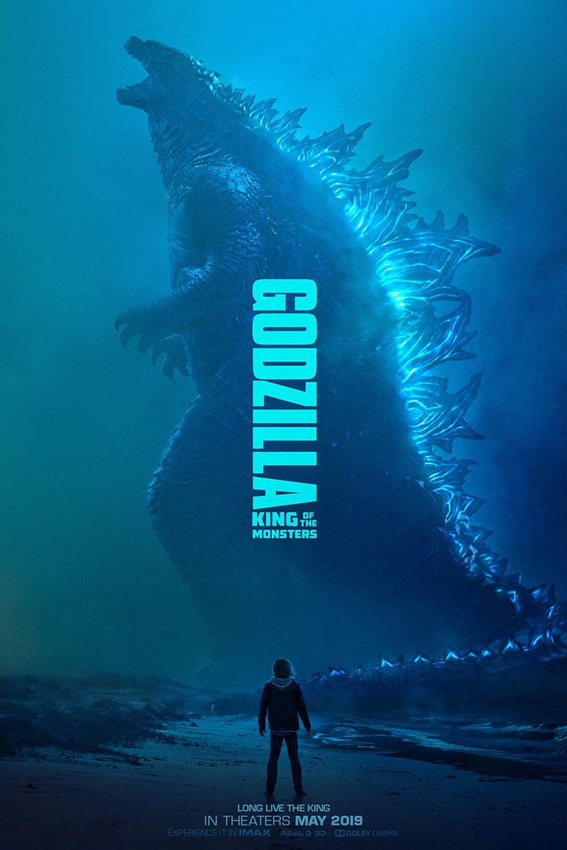 Godzilla poster features the towering blue kaiju with glowing dorsal plates above a lone figure on a dark shoreline.
