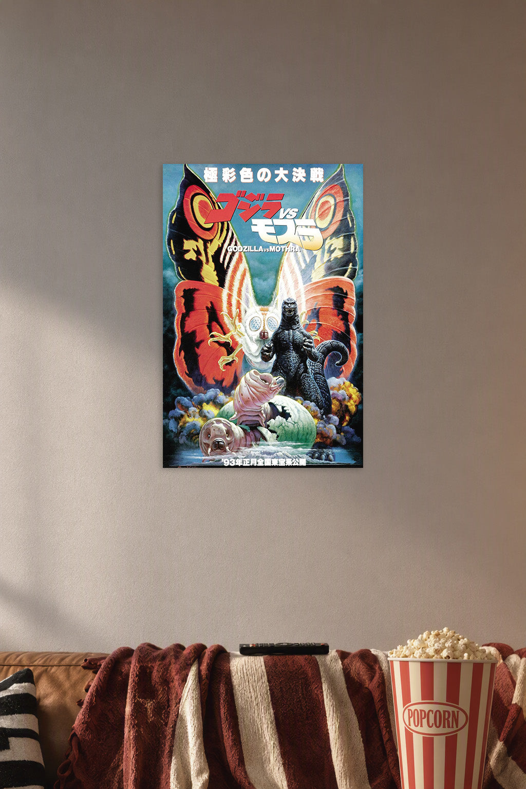 Godzilla vs. Mothra Kaiju Movie in a cozy movie room above a brown sofa with popcorn.