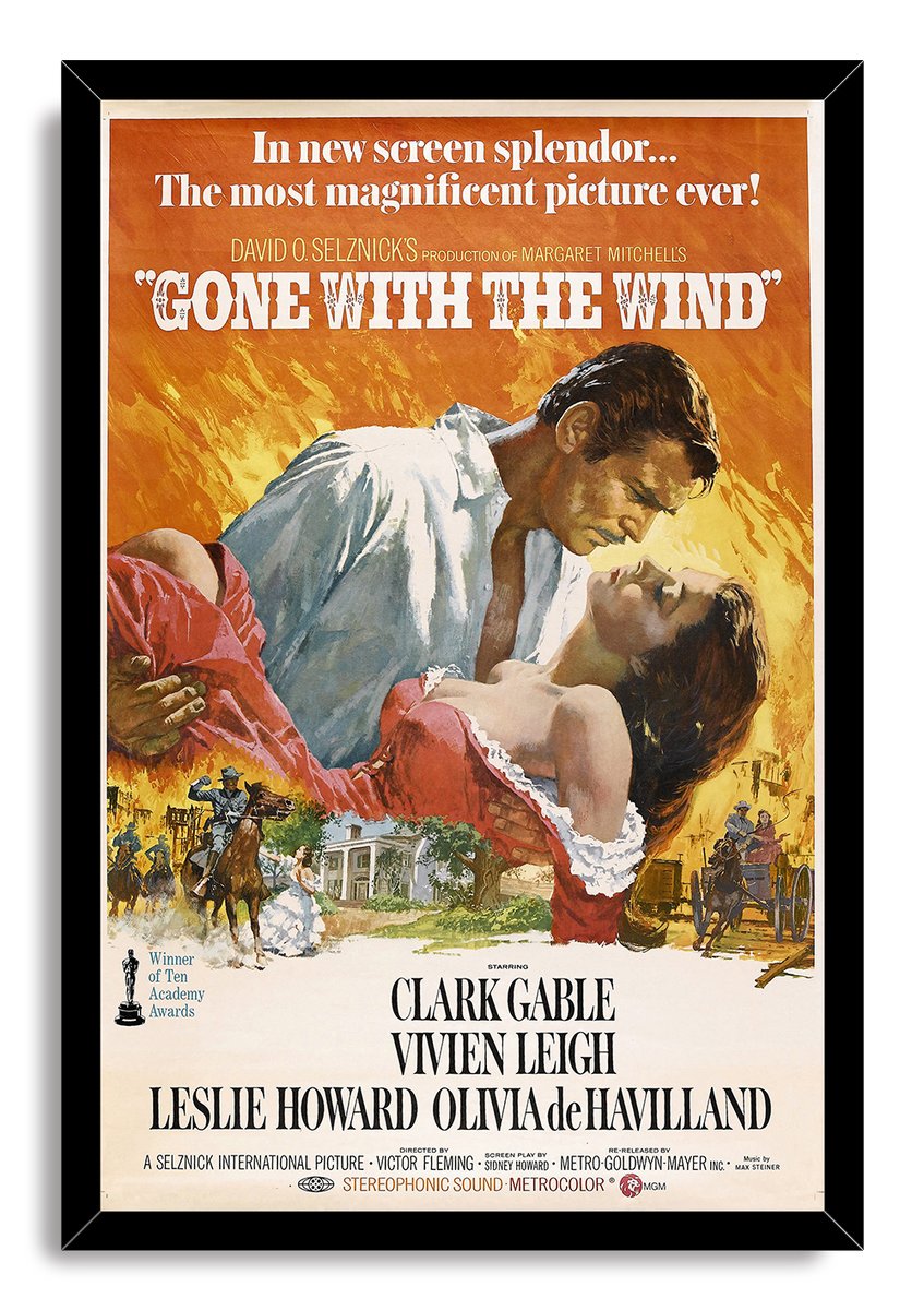 Gone with the Wind framed wall art print in a black frame, featuring the romantic couple over an orange battle and plantation scene.