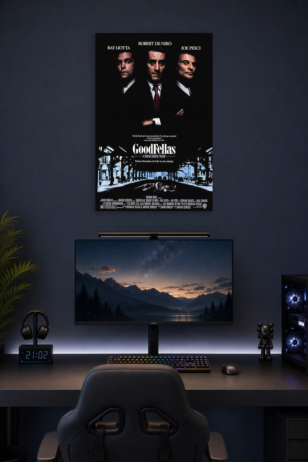 Goodfellas Movie Poster in a gaming desk setup above a monitor.