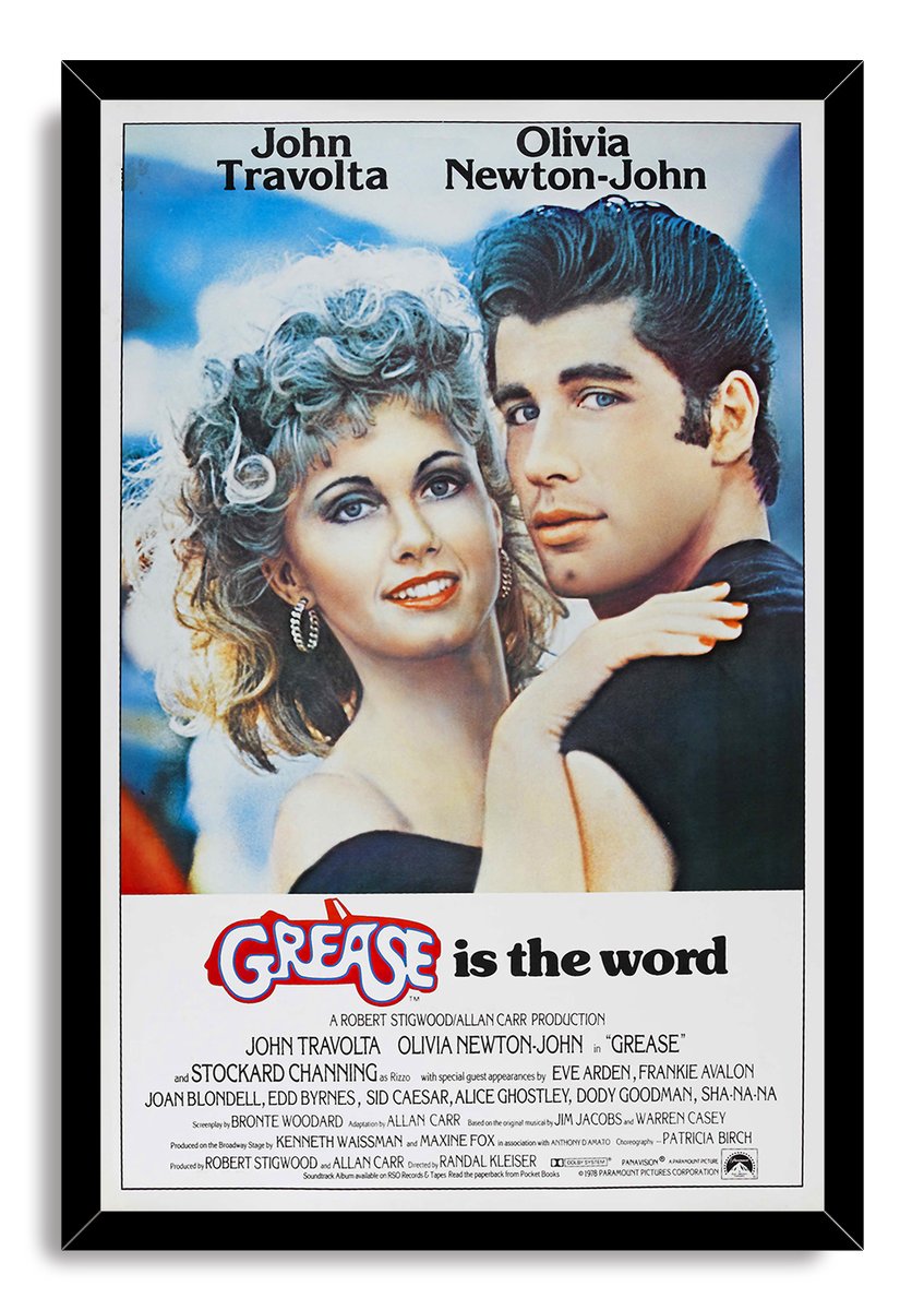 Grease movie poster wall art print in a black frame, featuring Olivia Newton-John and John Travolta embracing above film credits.