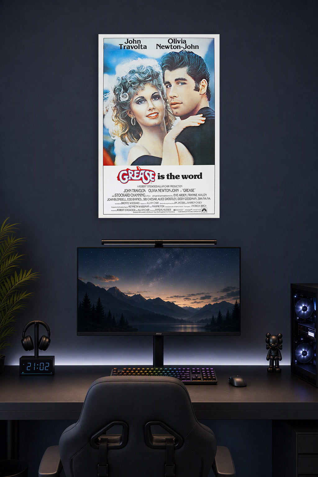 Grease Movie John Travolta Olivia Newton-John in a gaming desk setup above a monitor.