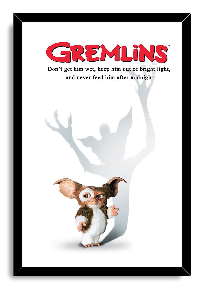 Gremlins framed wall art print with a black border, depicting Gizmo and his sinister gray shadow beneath the red logo.