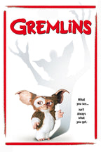 Gremlins poster features Gizmo beneath a looming gray monster shadow, with red title lettering and border on white.