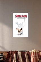 Gremlins in a cozy movie room above a brown sofa with popcorn.