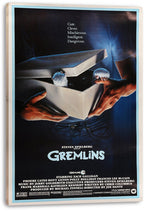 Gremlins movie poster canvas wall art featuring an open white box, furry Mogwai paws, dark blue artwork, and light wood edges.