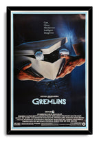 Gremlins movie poster wall art print in a black frame, depicting hands holding an open box with furry Mogwai paws peeking out.