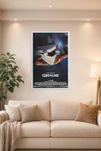 Gremlins Movie Poster in a bright living room above a beige sofa.