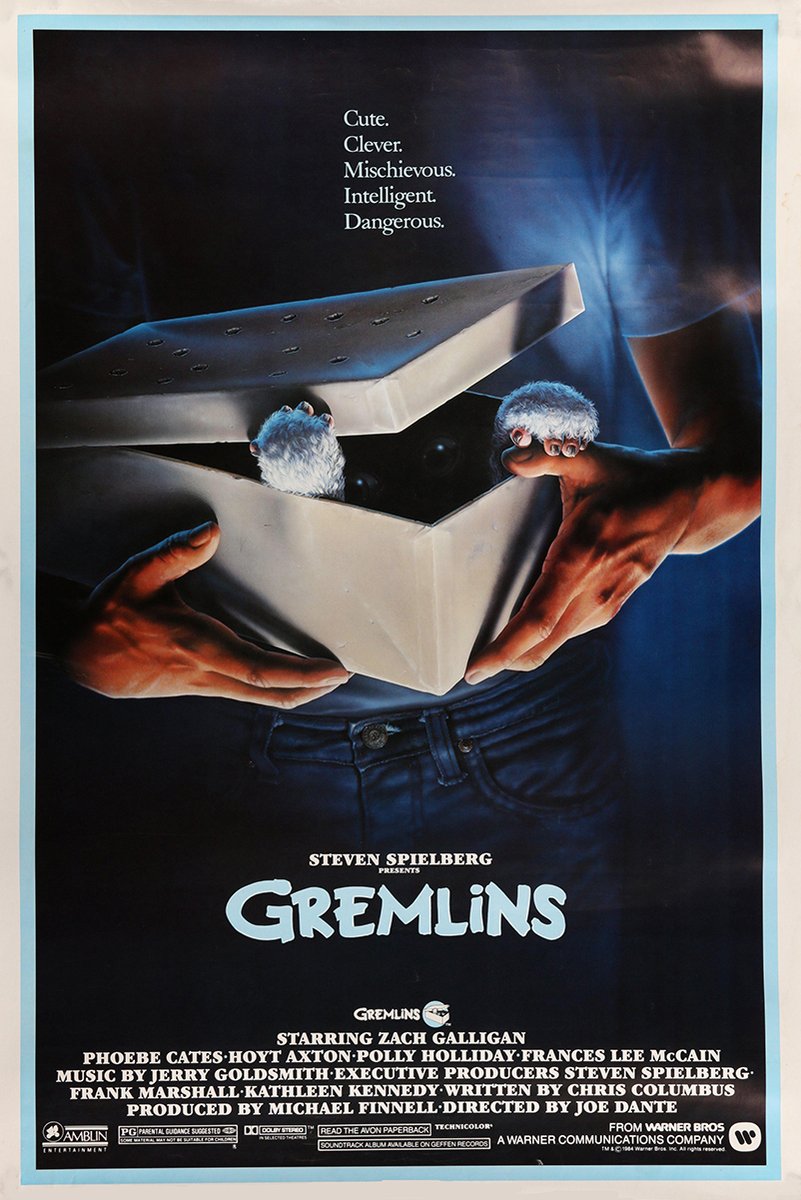 Gremlins movie poster paper print with hands opening a box as Gizmo's furry paws emerge against a dark blue background.