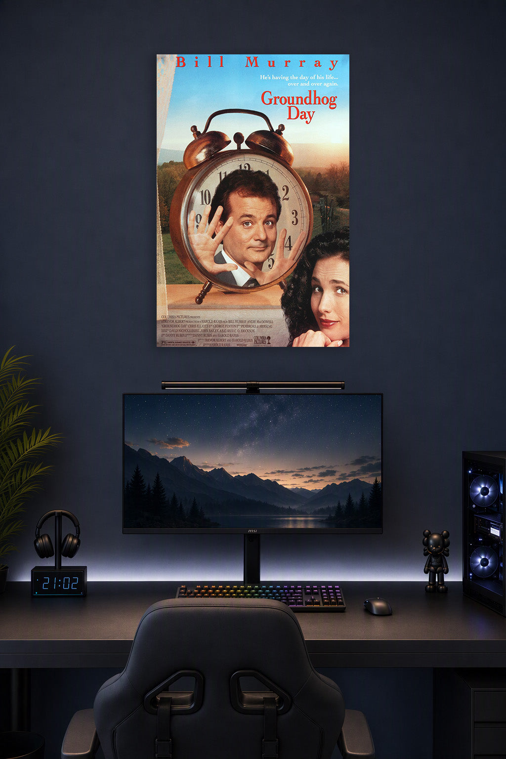 Groundhog Day Bill Murray Andie MacDowell in a gaming desk setup above a monitor.