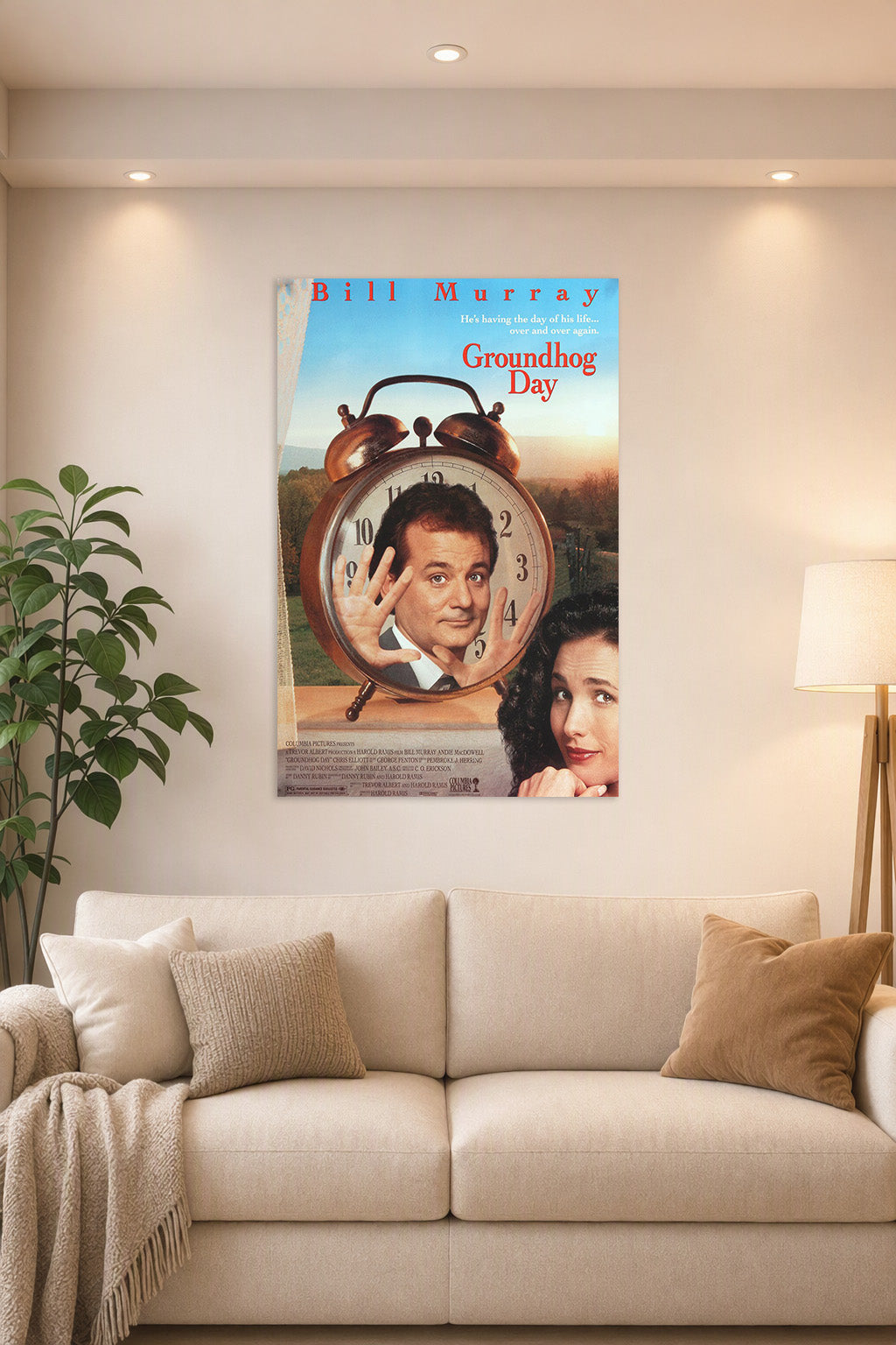 Groundhog Day Bill Murray Andie MacDowell in a bright living room above a beige sofa.