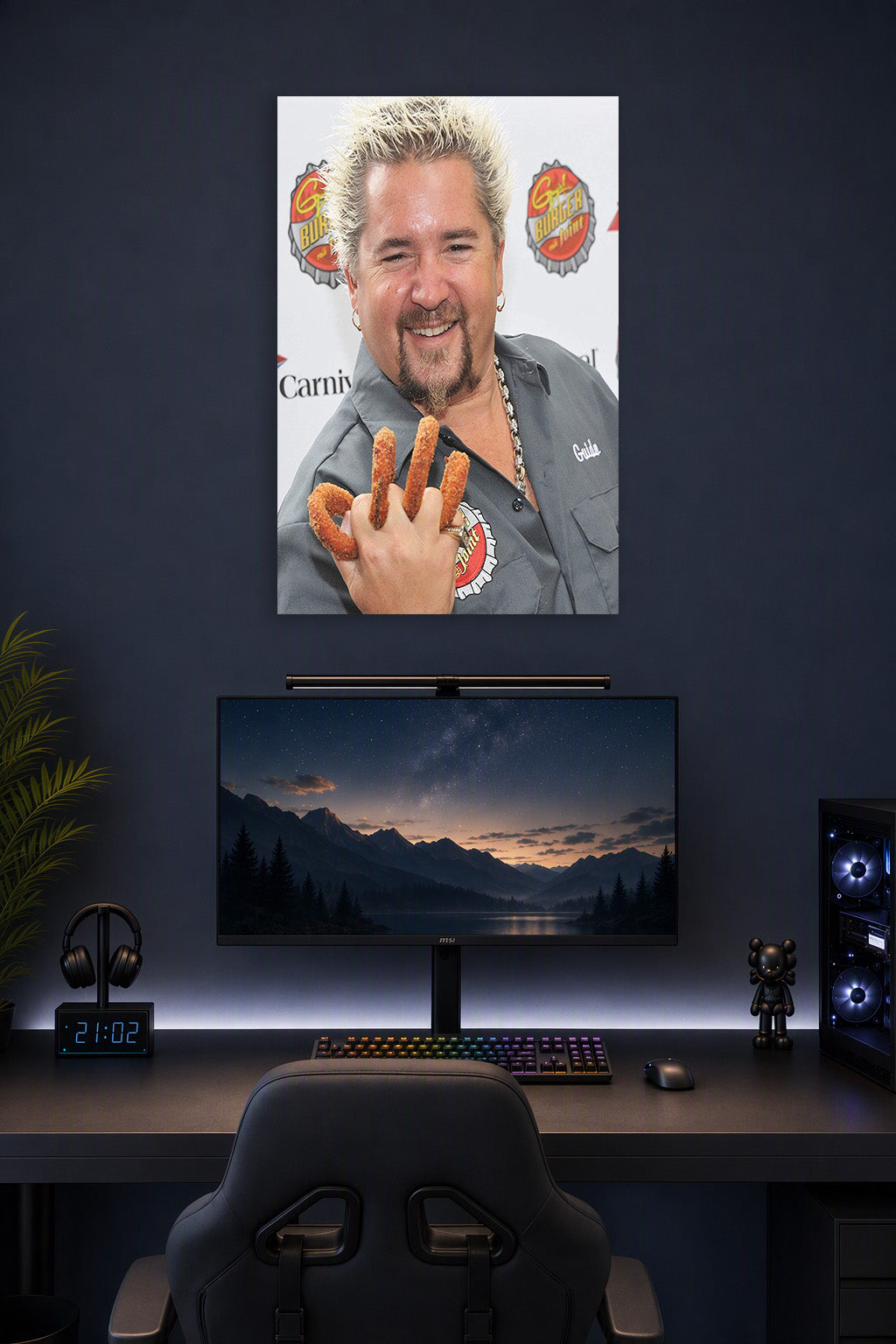 Guy Fieri in a gaming desk setup above a monitor.
