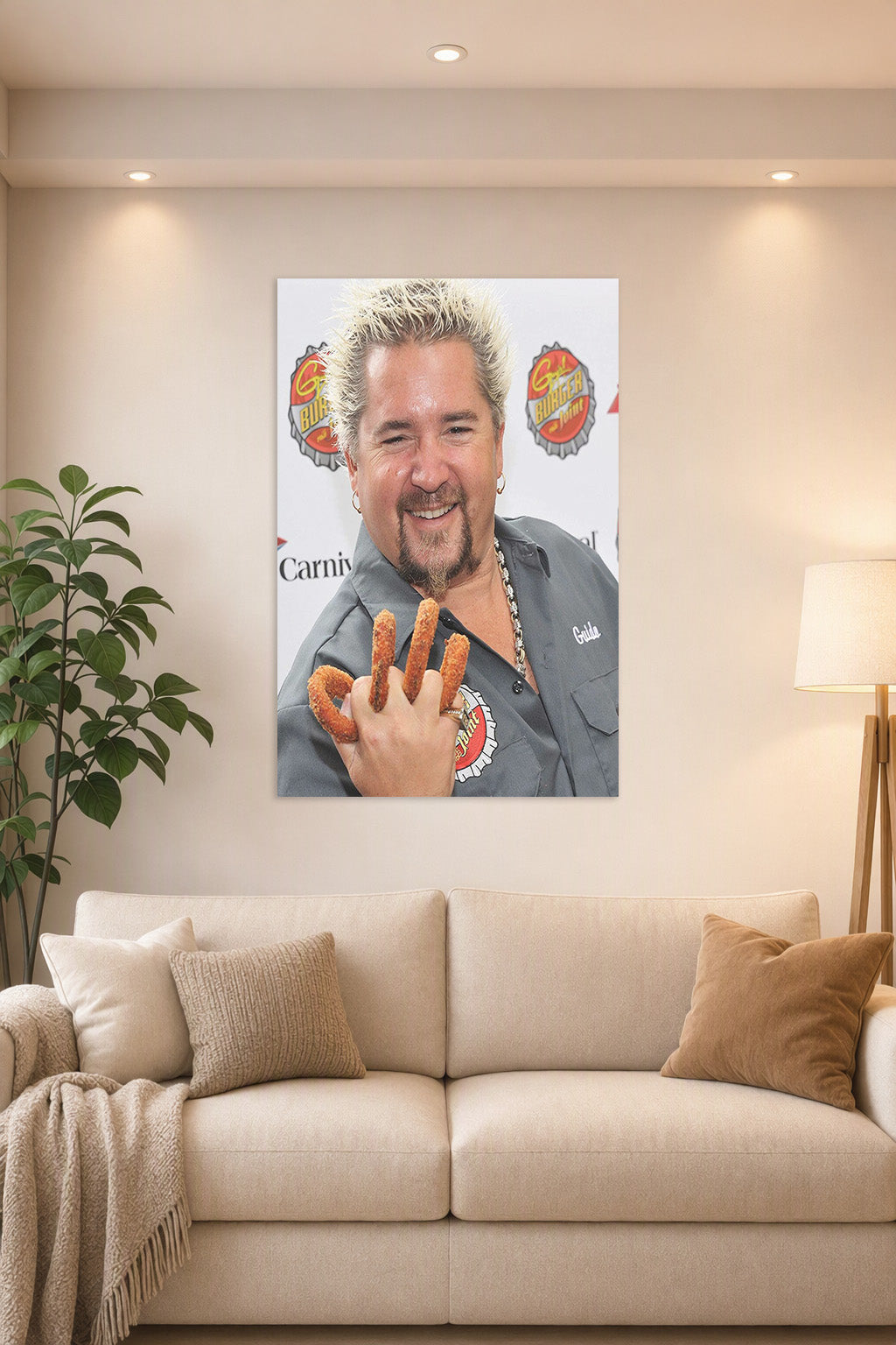 Guy Fieri in a bright living room above a beige sofa.