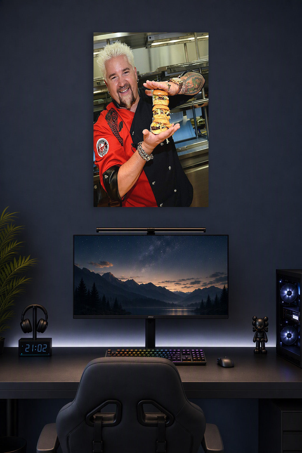 Guy Fieri in a gaming desk setup above a monitor.