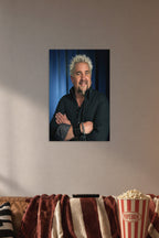 Guy Fieri in a cozy movie room above a brown sofa with popcorn.
