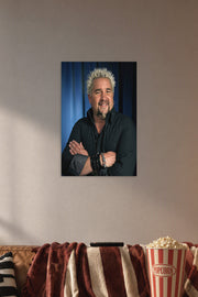 Guy Fieri in a cozy movie room above a brown sofa with popcorn.