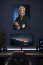Guy Fieri in a gaming desk setup above a monitor.