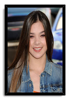 Hailee Steinfeld framed wall art print with a smiling close-up portrait, dark hair, denim jacket, and black border.