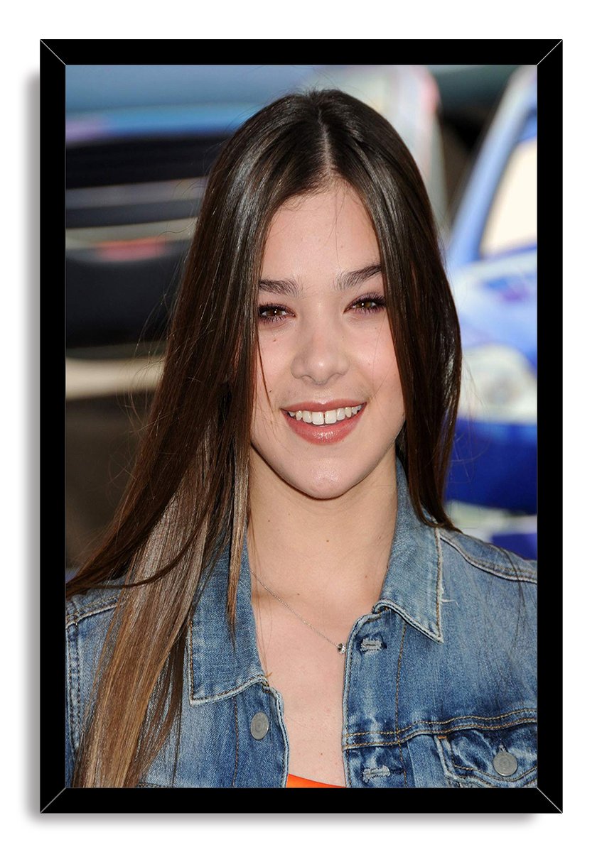 Hailee Steinfeld framed wall art print with a smiling close-up portrait, dark hair, denim jacket, and black border.