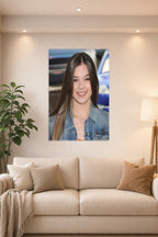 Hailee Steinfeld in a bright living room above a beige sofa.