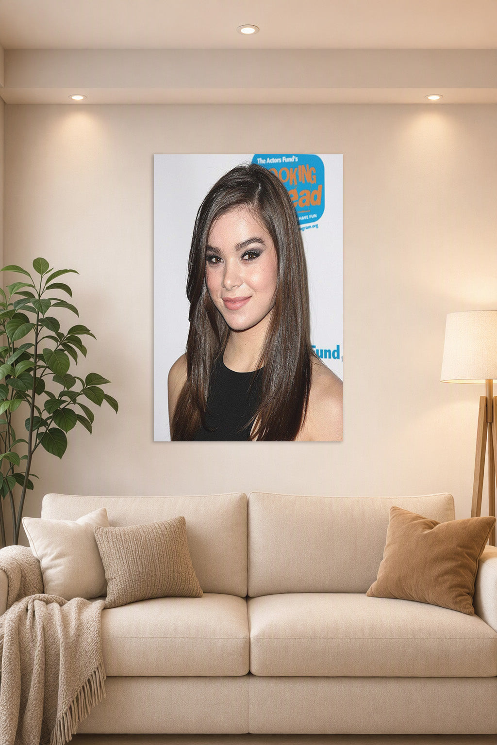 Hailee Steinfeld in a bright living room above a beige sofa.