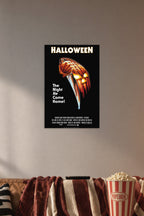 Halloween Movie Poster in a cozy movie room above a brown sofa with popcorn.