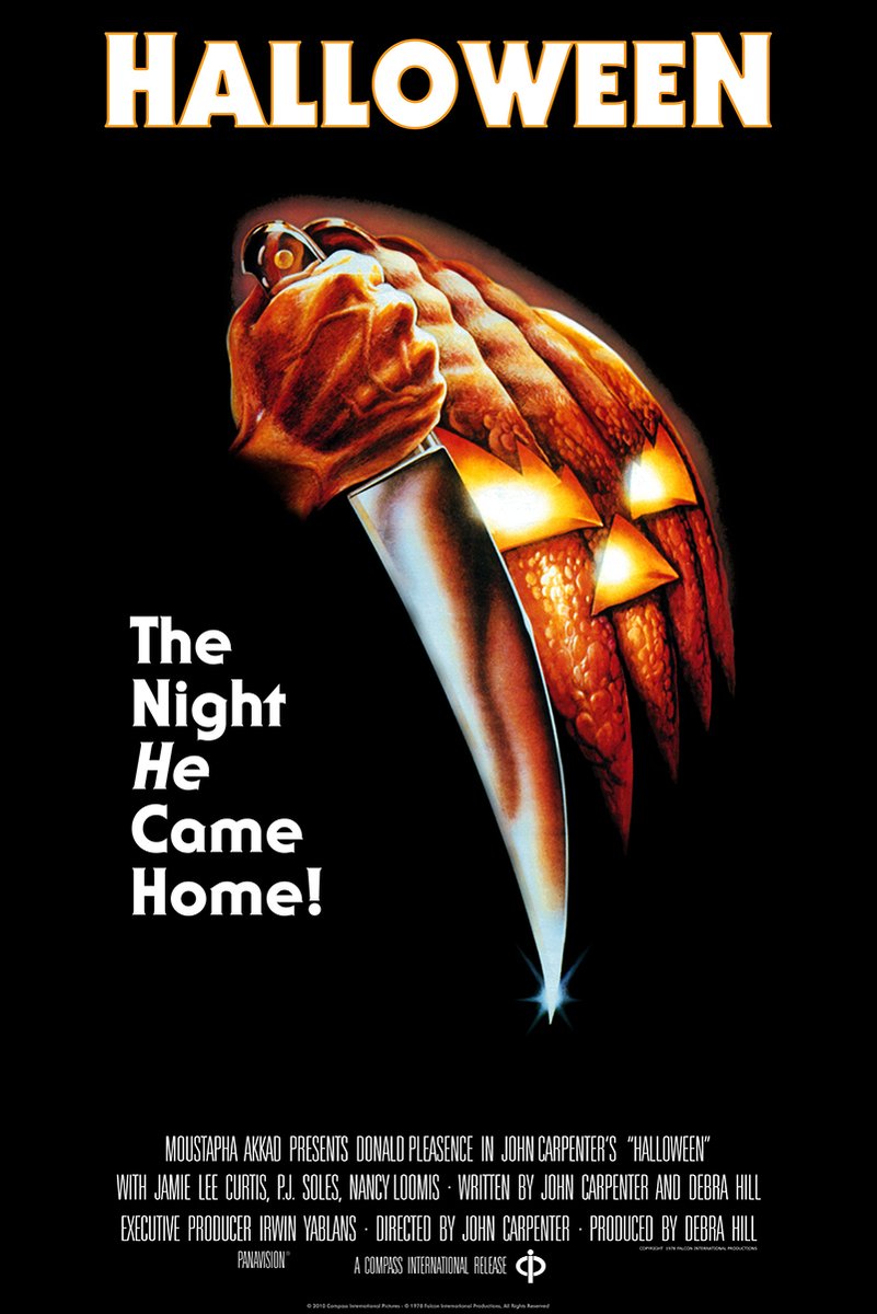 Halloween movie poster wall art print with a hand gripping a knife beside a glowing orange jack-o'-lantern on black.