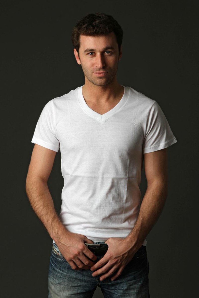 Handsome man wall art print portrays a dark-haired man in a white V-neck T-shirt and blue jeans against charcoal gray.