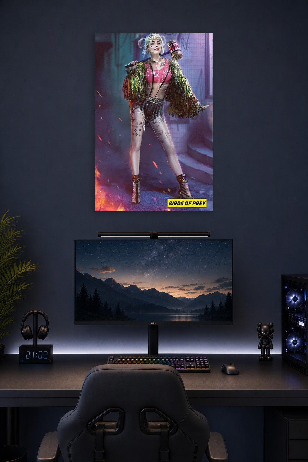 Harley Quinn from Birds of Prey in a gaming desk setup above a monitor.