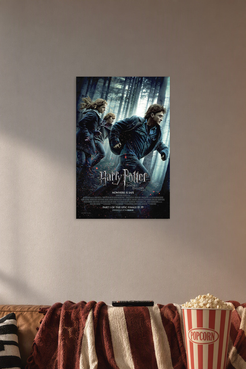 Harry Potter and the Deathly Hallows Part 1 in a cozy movie room above a brown sofa with popcorn.