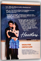 Heathers wall art print on a canvas wrap depicts Winona Ryder and Christian Slater embracing beside chalkboard writing.