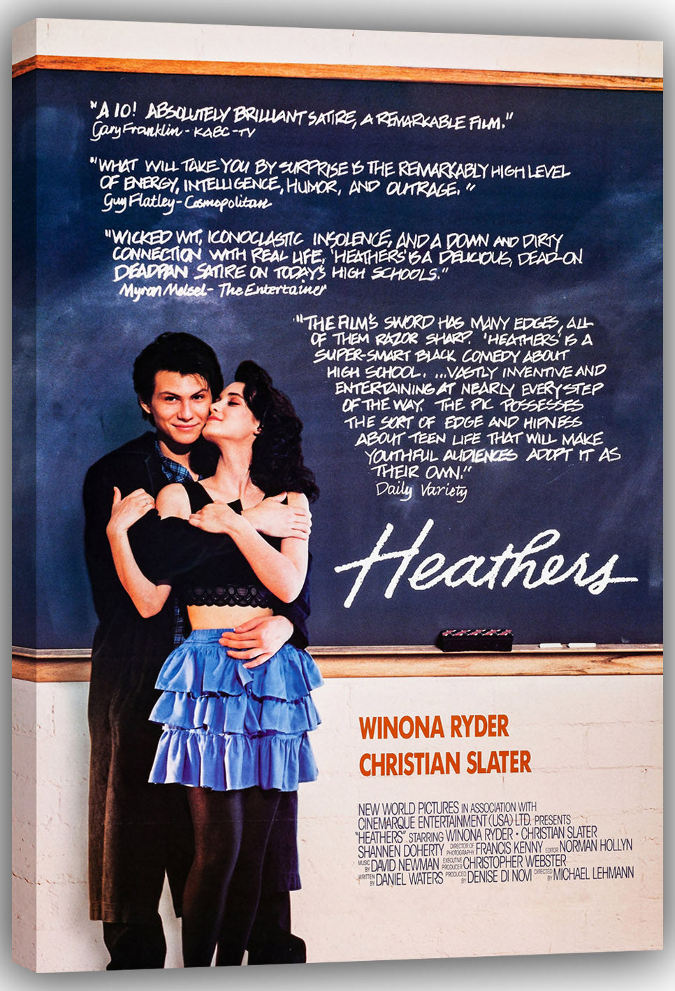 Heathers wall art print on a canvas wrap depicts Winona Ryder and Christian Slater embracing beside chalkboard writing.